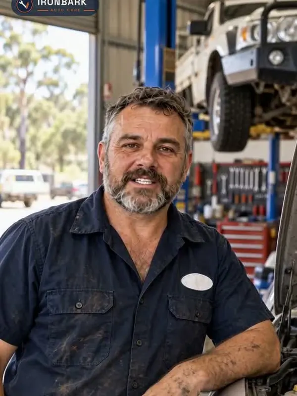 AI-generated mechanic in a workshop, a vehicle raised on the hoist behind him.